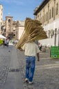 Man carrying brooms