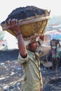 Man carrying coal basket on head