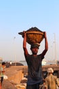 Man carrying coal basket on head