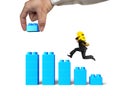 Man carrying dollar sign running bar graph block hand building