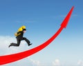 Man carrying dollar sign running on red arrow up graph Royalty Free Stock Photo