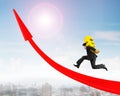 Man carrying Euro sign running on red arrow up graph Royalty Free Stock Photo