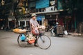 man carrying fruits on bicycle on road in Hanoi, Vietnam