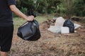 A man is carrying a garbage bag in a black bag. go to the landfill Royalty Free Stock Photo
