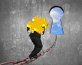 Man carrying golden puzzle on chain toward keyhole with sky Royalty Free Stock Photo