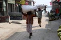 Man carrying goods on his head, Gosaba, India