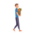 Man Carrying Grocery Paper Bag Full of Healthy Food, Household Activity, Housekeeping, Everyday Duties and Chores Royalty Free Stock Photo