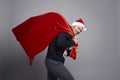 Man carrying a huge bag full of Christmas presents Royalty Free Stock Photo