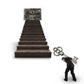 Man carrying key toward treasure chest on wood stairs Royalty Free Stock Photo