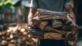 Man carrying a large stack of chopped firewood for heating outdoors Royalty Free Stock Photo