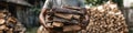 Man carrying a large stack of chopped firewood for heating outdoors Royalty Free Stock Photo