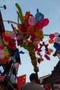 Man carrying many ballon animals on a stick