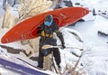 Man Carrying Orange Kayak In Snow Royalty Free Stock Photo