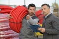 man carrying rolled hose