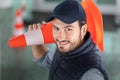 man carrying safety cone on shoulder Royalty Free Stock Photo