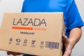 Man carrying shipping box from Lazada most popular online web shopping and international e-commerce company owned by Alibaba.,14