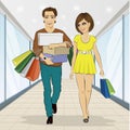 Man carrying stacks of boxes and shopping bags while his girlfriend looking at him Royalty Free Stock Photo