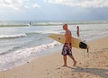 MAN CARRYING SURFBOARD Royalty Free Stock Photo