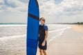 Man carrying surfboard over his head. Close up of handsome guy with surfboard on head at beach. Portrait of man carrying Royalty Free Stock Photo