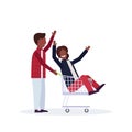 Man carrying trolley cart with woman happy african american couple having fun supermarket shopping concept male female Royalty Free Stock Photo