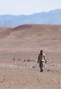 Man carrying water through desert Royalty Free Stock Photo