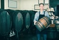 Man carrying wine wood in hands