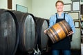 Man carrying wine wood in hands