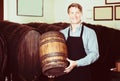 Man carrying wine wood in hands