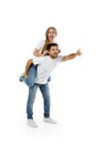 Boyfriend giving piggyback to girlfriend on white background Royalty Free Stock Photo