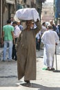 A man carrys a load of goods through the Khan el Khal'ili Bazaar in Cairo, Egypt.