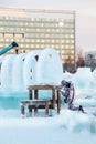 Man carves ice sculpture