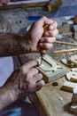 Man carves intricate wooden alphabet blocks