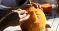 Man carving Helloween pumpkin