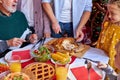 Man carving roast chicken at table at a christmas dinner, with family Royalty Free Stock Photo