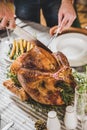 Man carving roasted turkey