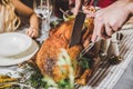 Man carving roasted turkey