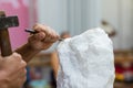 Man carving stone statue