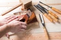 Man carving wood with handtools Royalty Free Stock Photo