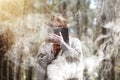 A man in a cassock spends a ritual in a dark forest