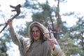 A man in a cassock spends a ritual in a dark forest