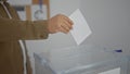 A man casting a ballot in a voting box inside a room, suggesting a democratic election process Royalty Free Stock Photo