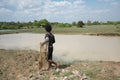 A man casting a net along National Highway 219 near Sambor Prei Kuk in Kampong Thom, Camb