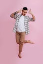 A man in casual clothes dances barefoot standing on one leg Royalty Free Stock Photo