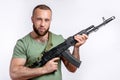 Man in casual clothing with sniper rifle aiming  on white Royalty Free Stock Photo