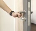 Man catch Door Handles stainless steel on door wood to open Royalty Free Stock Photo