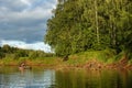 A man catches fish on the river