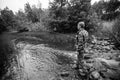 A man catching fish on the lake. Black and white photo. Royalty Free Stock Photo