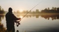 Man catching fish, pulling rod while fishing from lake or pond. Fisherman with rod, spinning reel on river bank. Sunrise. Royalty Free Stock Photo