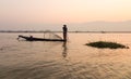 A man catching fish at sunrise on the lake in Inlay, Myanmar Royalty Free Stock Photo