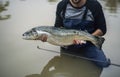 Man caught salmon fish holding it Royalty Free Stock Photo